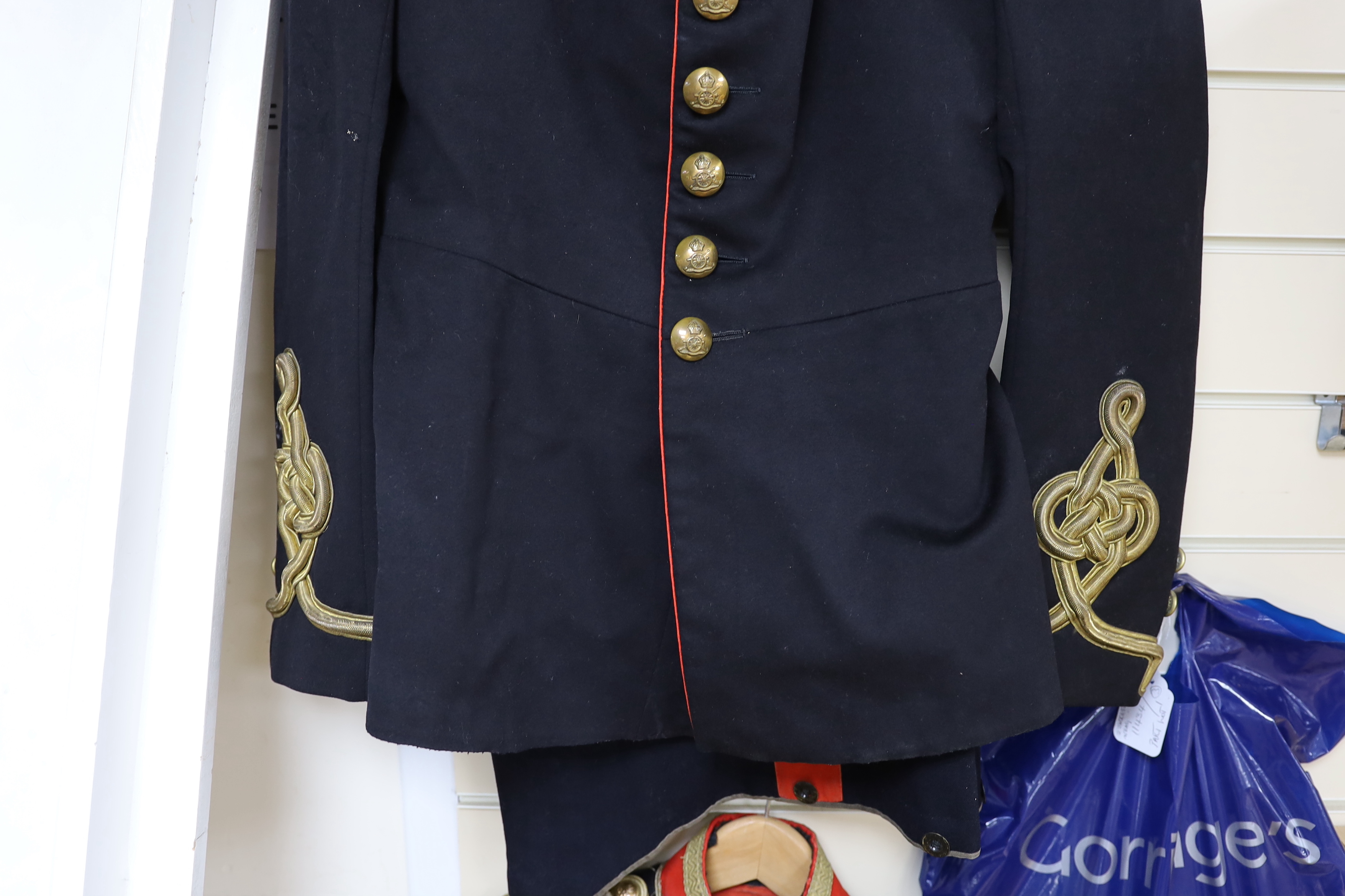 An early 20th century Royal Artillery officers dress uniform, comprising a jacket and trousers, both with original maker’s labels for J. Daniels and Co., with owner’s name ‘Major G.H. Tristram R.A.’ added in pen, a Mess